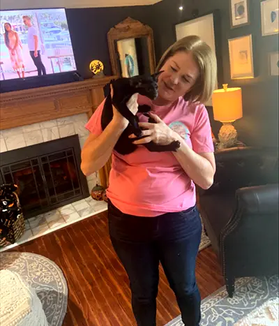 Happy Cataristocrat cattery customer holding an adopted black oriental shorthair kitten