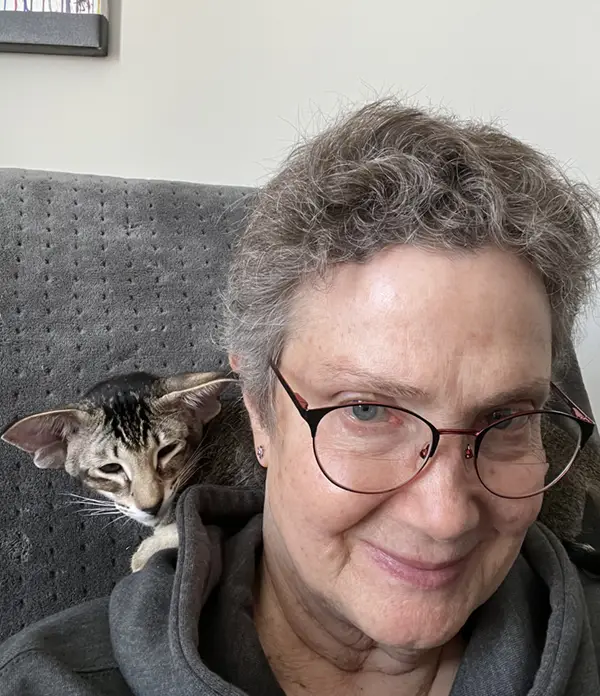 happy cataristocrat customer with oriental shorthair kitten on neck