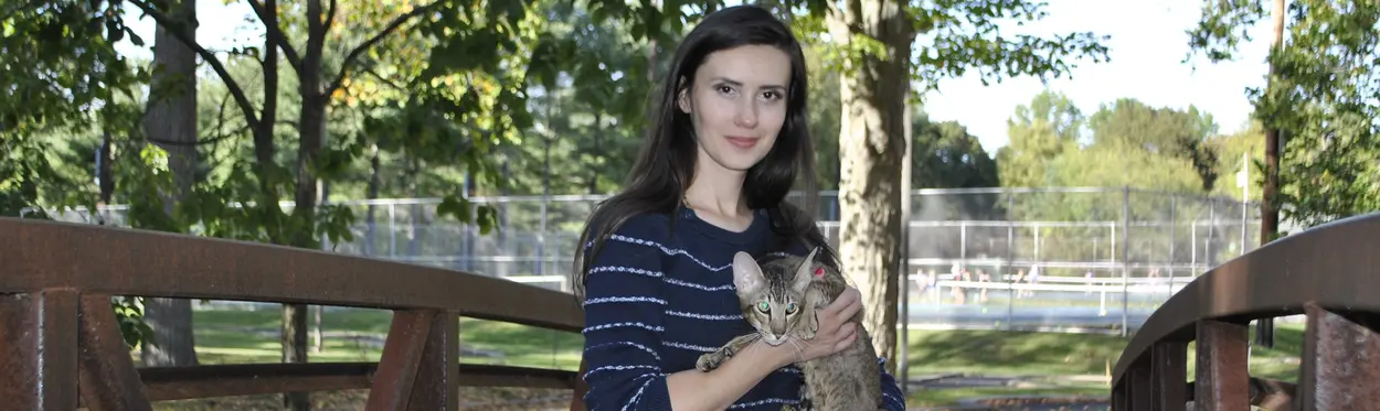 Olga Shatokhina, a cat breeder, holds oriental shorthair