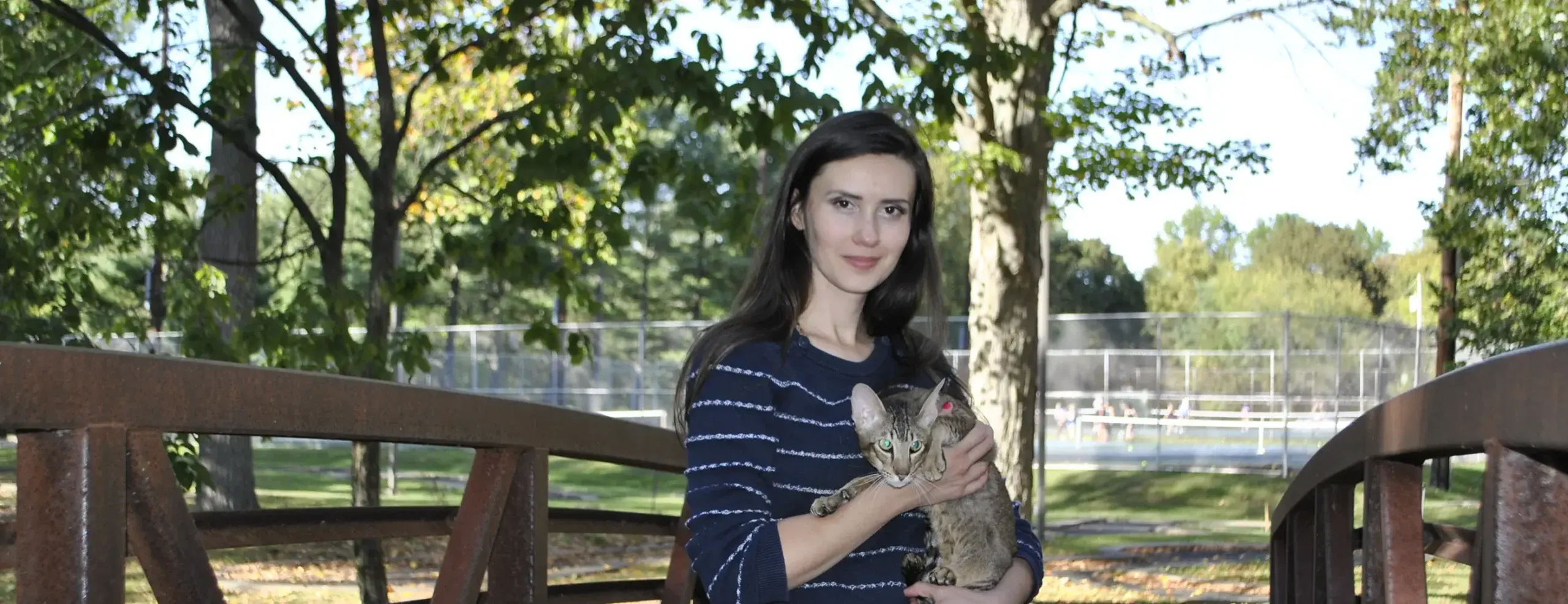 Olga Shatokhina, a cat breeder, holds oriental shorthair cat